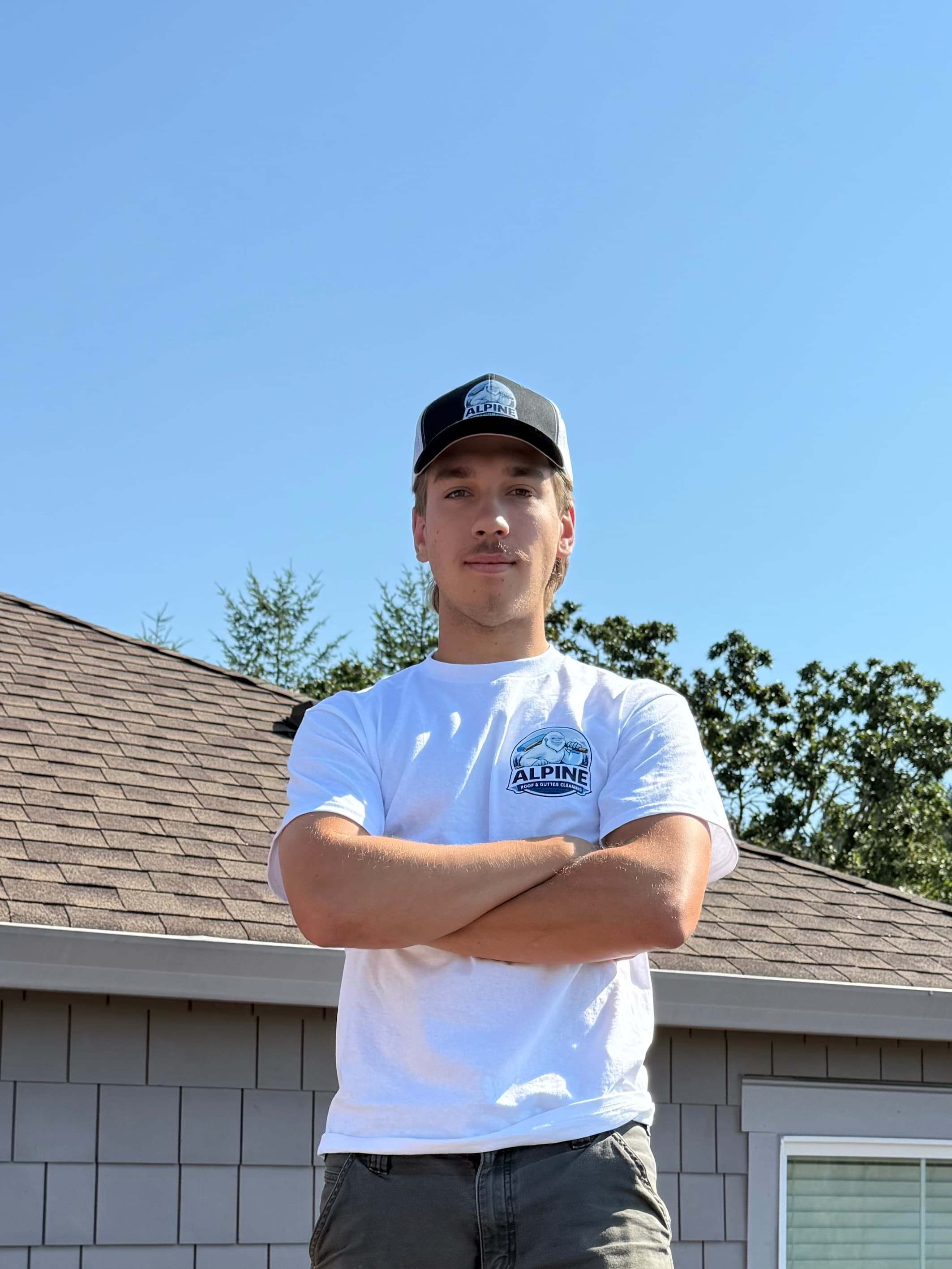 David from Alpine Roof and Gutter Cleaning standing in front of a home