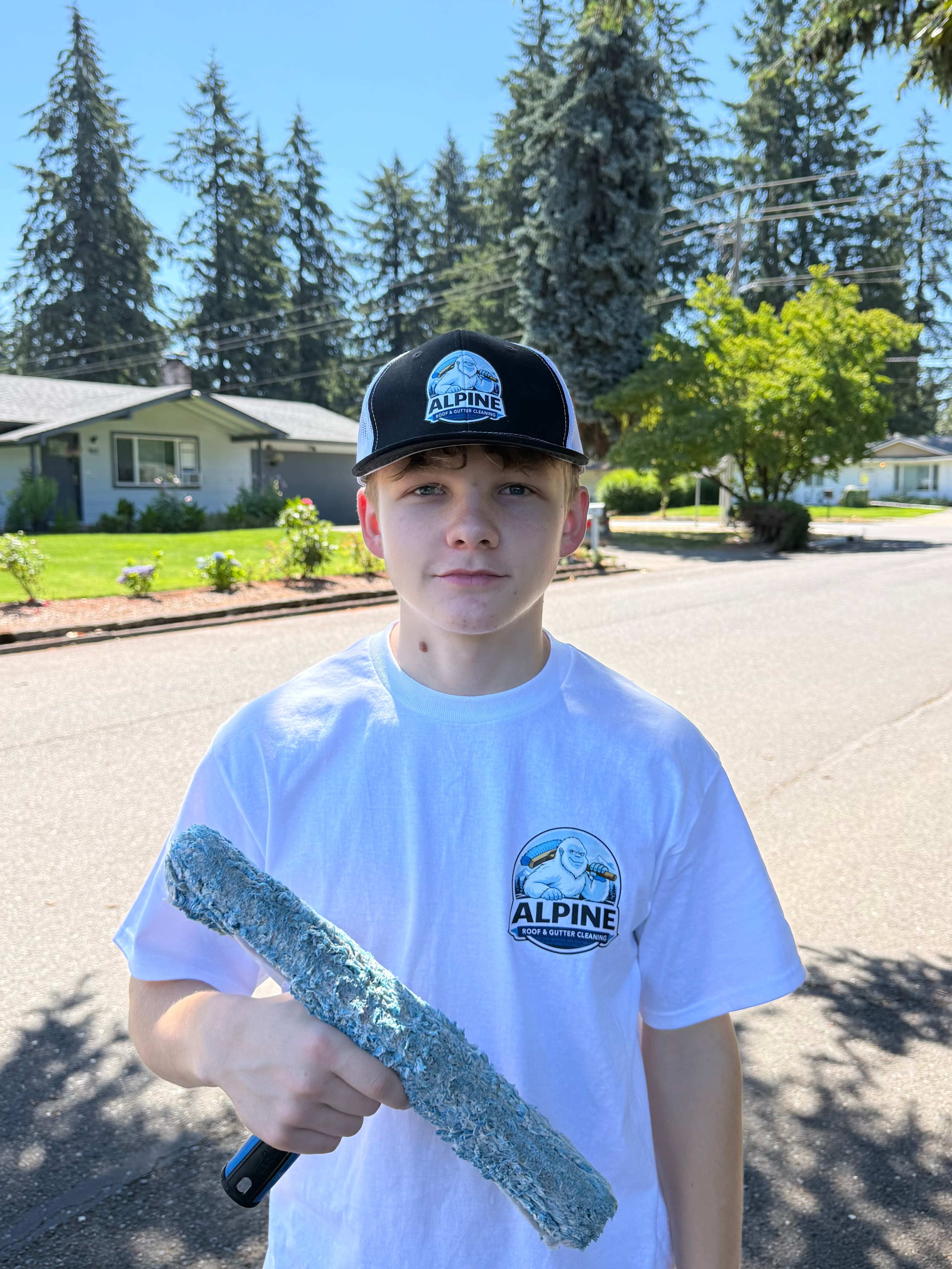 Anthony from Alpine Roof and Gutter Cleaning holding a window cleaning tool